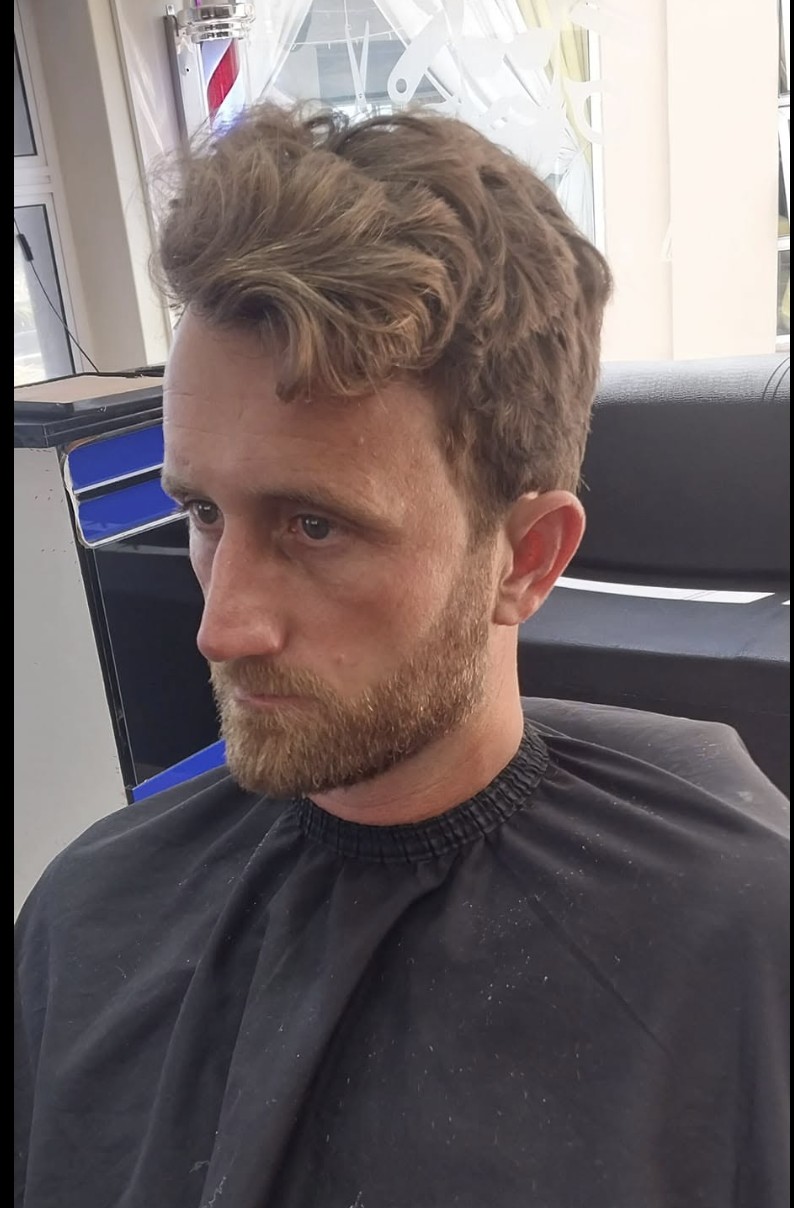 Textured messy top with a tapered beard — recent haircut at Bay Barber.