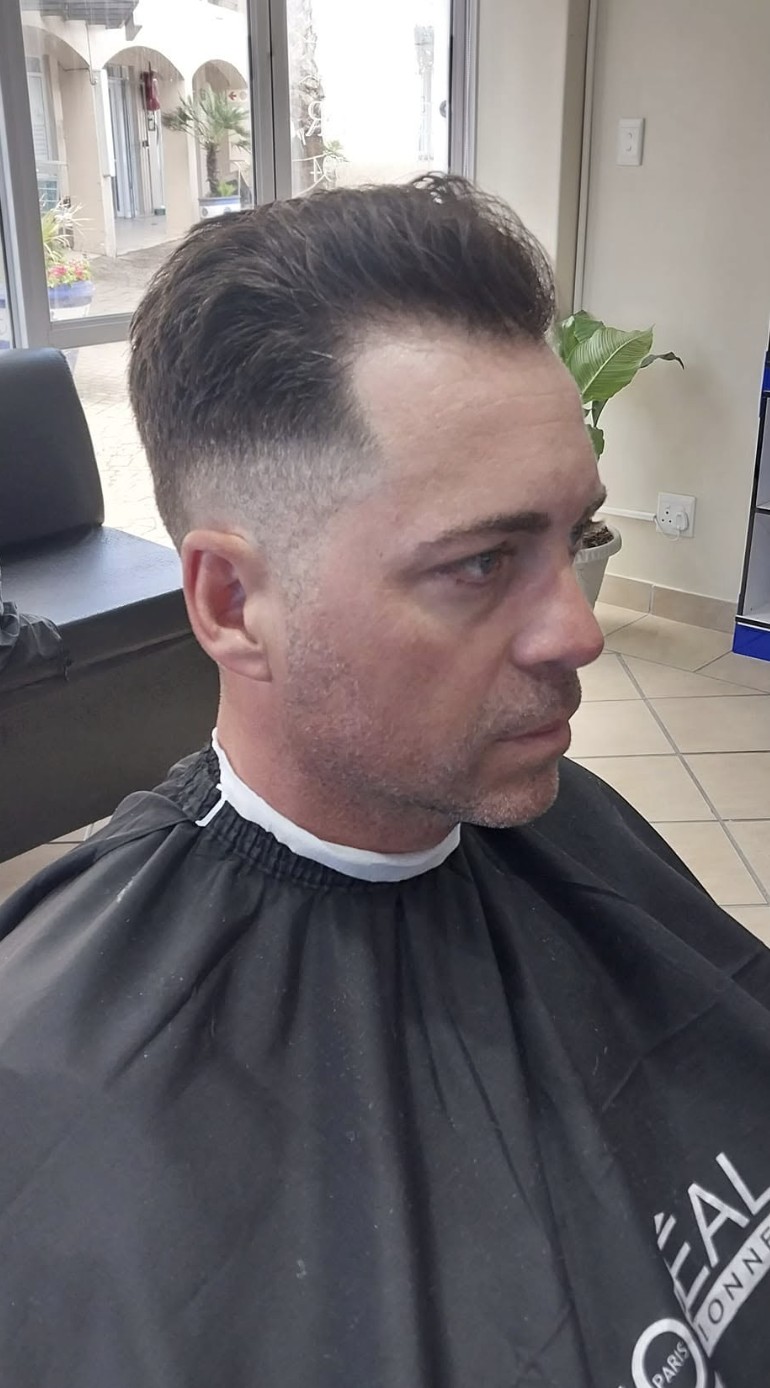 Brushed-back quiff with a skin fade at Bay Barber