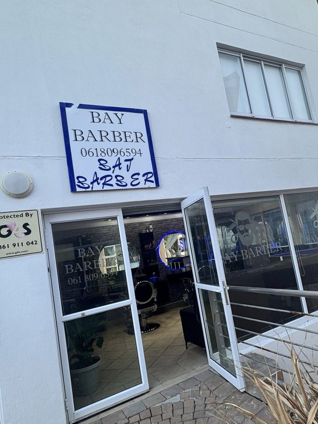 Bay Barber shop signage and open doorway at Port St Francis.