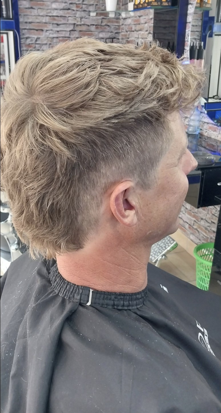 Textured cut with a tapered back and sides at Bay Barber